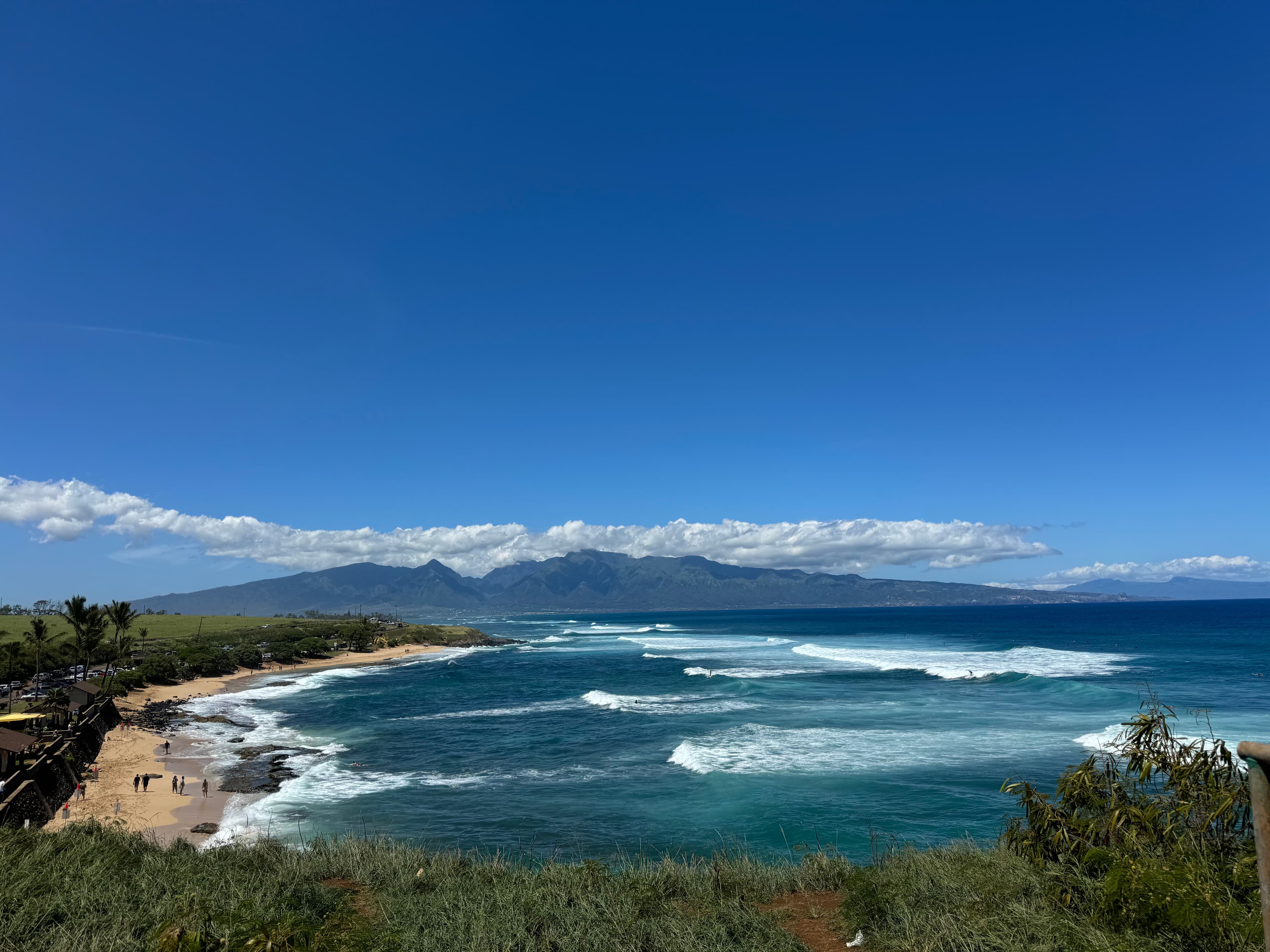 Wide Maui beach with mountains and surf — quick coastal escape mood